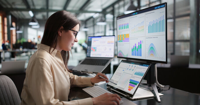 Young Female Financial Analyst Reviewing Important KPI Data