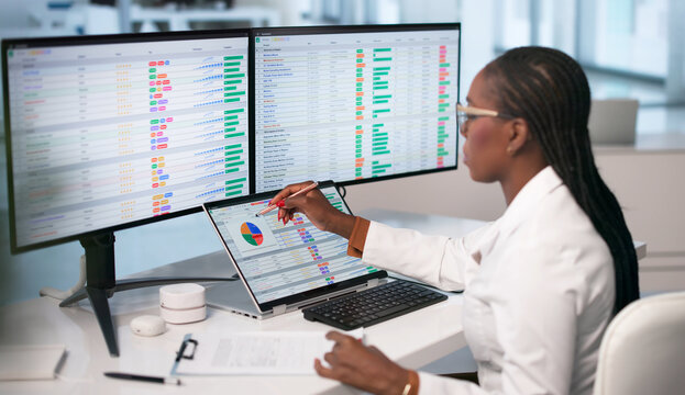 Woman Reviews Medical Billing Codes On Laptop