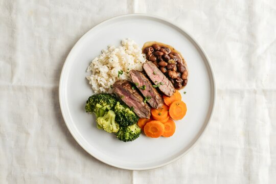 Healthy plate of sliced steak with broccoli rice and beans broccoli balanced
