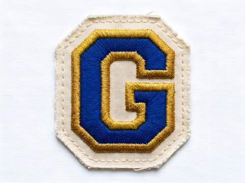Embroidered letter g patch isolated on white background