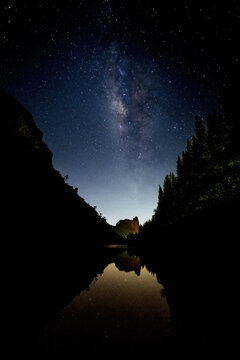The Milky Way rises between two mountains above the Thap Put mine in Phang Nga Province, Thailand.