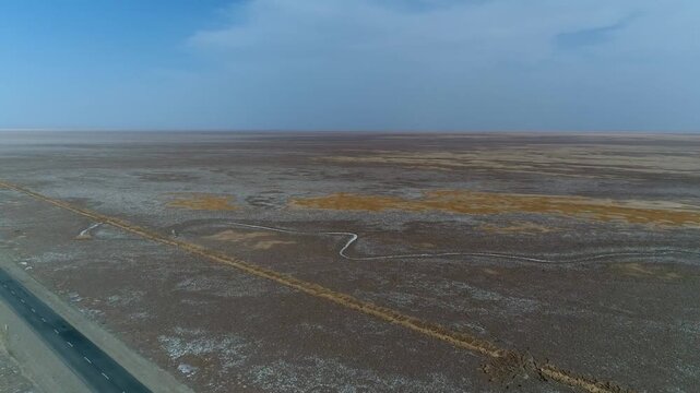 Detailed drone perspective showing geometric patterns formed by salt deposits in desert marsh landscape.