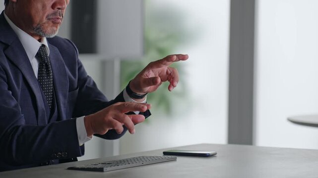 A male business professional interacting with a screen in mid-air. VR, virtual, operation, touch, office, business, development.