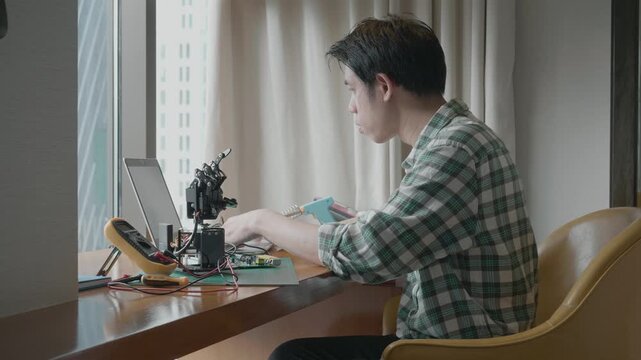 A hobbyist immersed in electronics, working with circuits and devices in a modern workspace. This image captures the essence of creativity and innovation in the field of electronics.