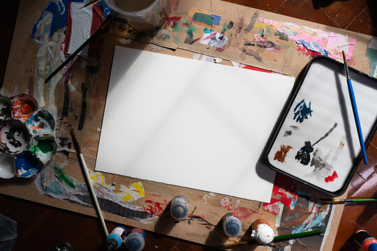Artist's workspace: Paper ,wet palette ,acrylic color and brushes