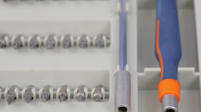 A set of metal bits for installation work in a plastic case.