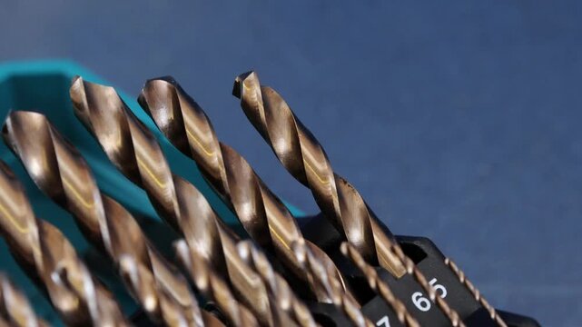 A set of drills for drilling metal in a plastic case.