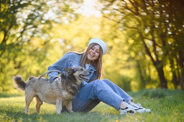 Fototapeta premium Young woman enjoying summer day with her dog