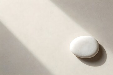 Obraz premium Minimalist white cosmetic jar on stone surface with organic shadows for skincare branding.