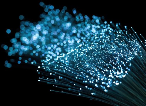 Abstract light streaks of glowing blue fibers, bokeh effect on black background