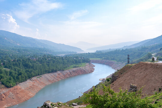 River flowing into Charvak reservoir in Uzbekistan. Mountainous landscape of Central Asia. Concept: travel, tourism design, ecology, natural