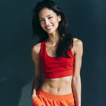 extremely beautiful asian supermodel with toned abs smiling confidently, elegant asian fashion model with athletic physique and radiant smile