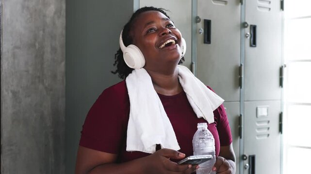Athlete Hydrating and Using Smartphone Post Workout