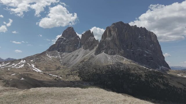 Majestic Alpine Mountain Peaks with Valley Road and Buildings
