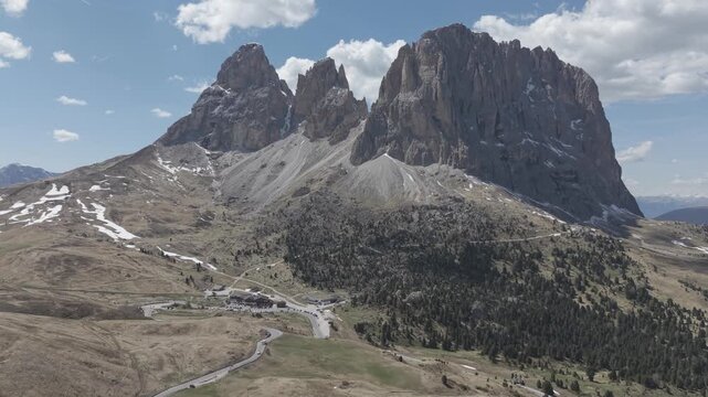 Majestic Alpine Mountain Peaks with Valley Road and Buildings