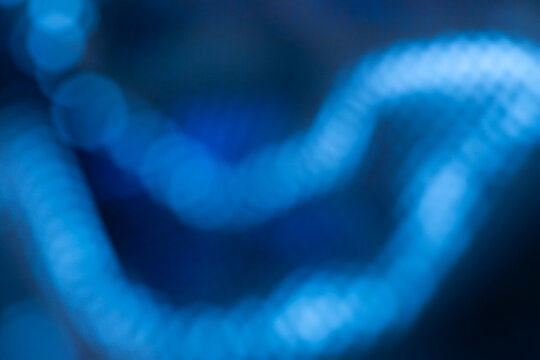 Blurred blue sparkles. Soft, bright and vibrant bokeh background. Abstract high resolution full frame defocused background with copy space.