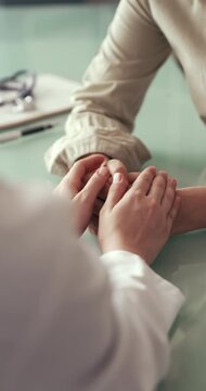 Doctor comforting patient during consultation