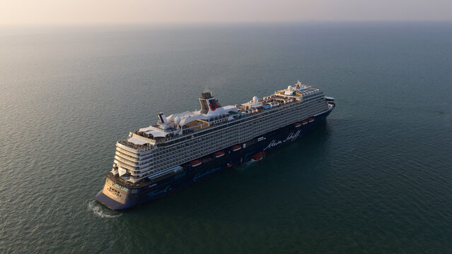 Pattaya City, Thailand - 06 March 2026: Aerial view of Mein Schiff 6 docked off the coast of Pattaya, Thailand, at golden hour sunset, showcasing luxury cruise travel.