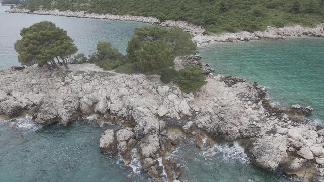 Small Rocky Island with Pine Trees in Turquoise Sea