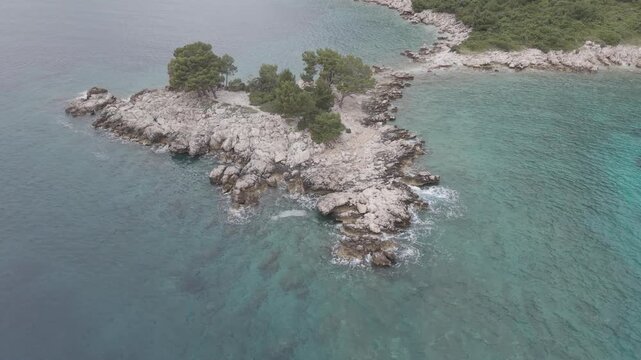Small Rocky Island with Pine Trees in Turquoise Sea