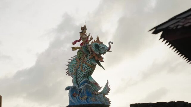 Mythological gaja mina statue against a cloudy sky
