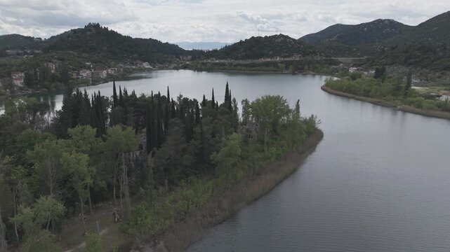 Aerial View of Serene Mountain Lake Surrounded by Green Hills