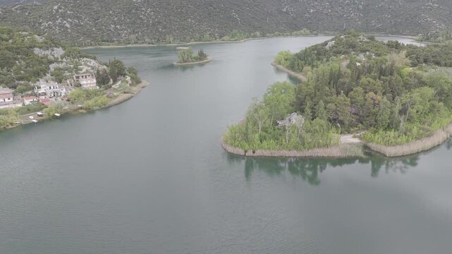 Aerial View of Serene Mountain Lake Surrounded by Green Hills