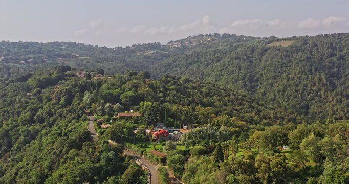 Tanneron France Aerial v15 birds eye view overlooking at hillside small village with secluded designer residential mansion surrounded with beautiful mountainous landscape - July 2021