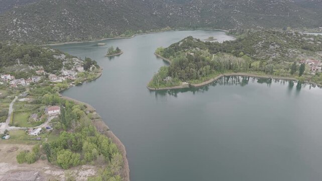 Aerial View of Serene Mountain Lake Surrounded by Green Hills