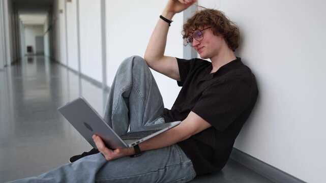 Vertical screen thoughtful student sitting with laptop reflecting on studies searching for solutions making decisions and planning future academic goals