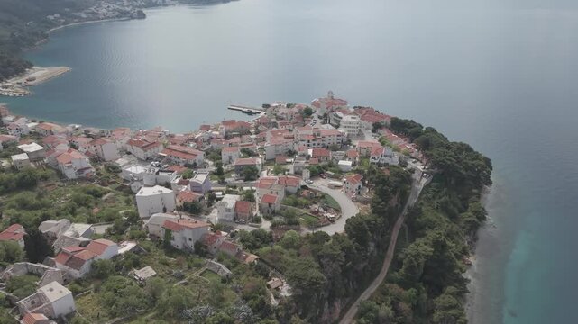 Aerial View of Coastal Village with Church Tower and Mountain Bay