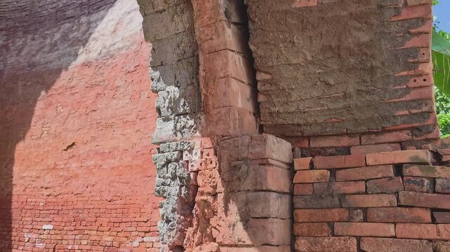 Close-up of weathered brick archway and textured wall of an abandoned traditional brick kiln, Mekong Delta, Vietnam