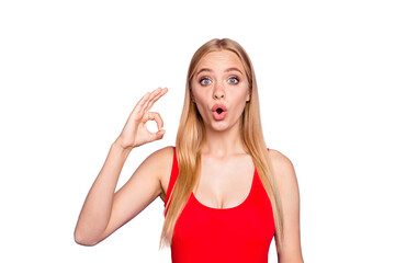 Attractive blonde girl wearing red swim suit shocked showing ok okay sign. Isolated over violet pastel background © deagreez