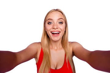 Self portrait of attractive cheerful blonde funny gorgeous playful flirting girl wearing red swim suit. Isolated over violet pastel background © deagreez