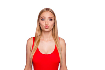Portrait of attractive pleased blonde gorgeous girl wearing red swim suit with pouted lips. Copy space. Isolated over violet pastel background © deagreez