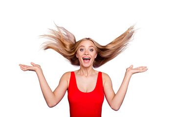 Portrait of attractive surprised blonde gorgeous girl wearing red swim suit with opened mouth, wind blows hair. Isolated over violet pastel background © deagreez