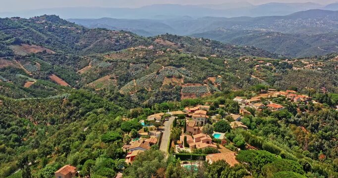 Tanneron France Aerial v19 establishing dolly in shot capturing housing estates at les mauberts, high altitude hillside plantation and pristine mountainous landscape - July 2021