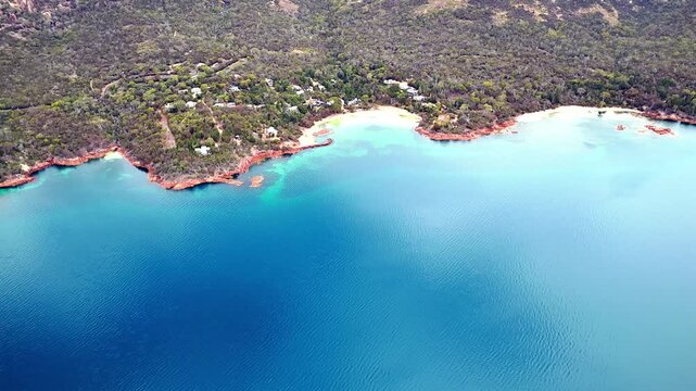 Aerial vertical panorama Coles bay waters up to The Hazards mountains of Freycinet Peninsula in Tasmania.