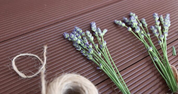 Two lavender bouquets tied with twine on wooden deck background. Flat lay composition for social media content creator and blogging backdrop. Elegant minimalist aesthetic decoration with copy space fo