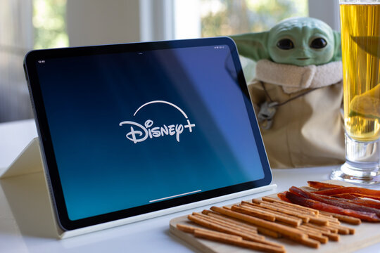 Tablet Apple iPad Air with multinational entertainment company Disney plus provides streaming media and video on the screen