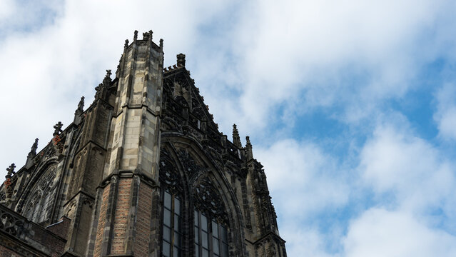 Gothic cathedral top architecture close up against blue sky