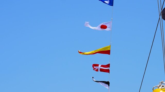 National flags fluttering on a ship.