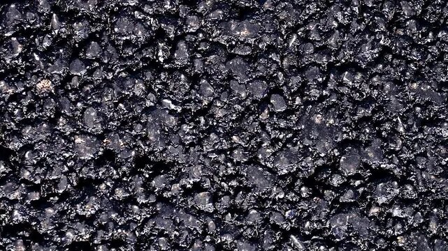 Textured surface of fresh black asphalt.