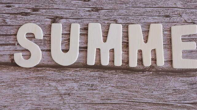 wooden letters spelling "summer" from left to right
