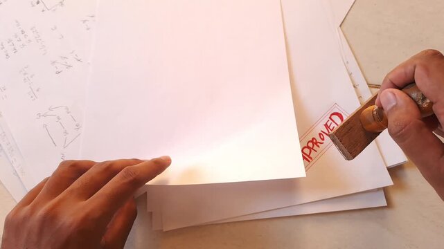 Red rubber stamp APPROVED on torn white paper with data background. Business document, contract, agreement. 4K video for paper background, white background, stamp, torn paper, data, business, office