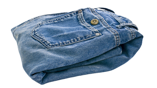 Folded blue denim jeans with metal button and pockets