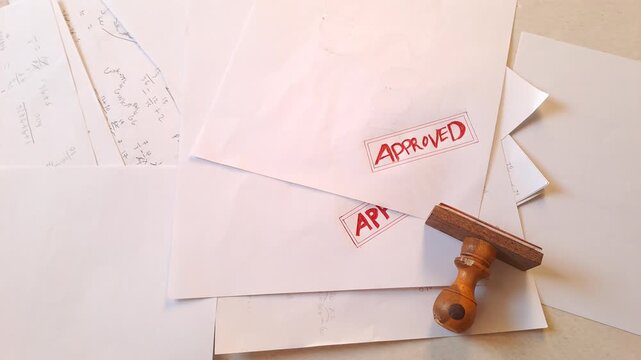Red rubber stamp APPROVED on torn white paper with data background. Business document, contract, agreement. 4K video for paper background, white background, stamp, torn paper, data, business, office