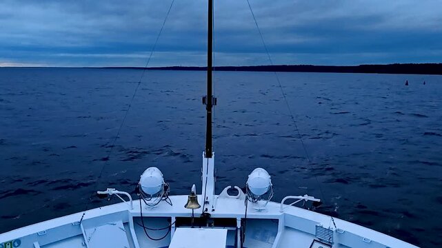Cruise ship bow on a calm dark sea.