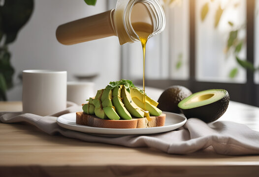 Pouring olive oil onto freshly sliced avocado toast served on a wooden kitchen table