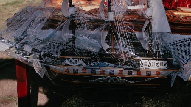 Handcrafted Wooden Model Ship Wrapped in Protective Plastic